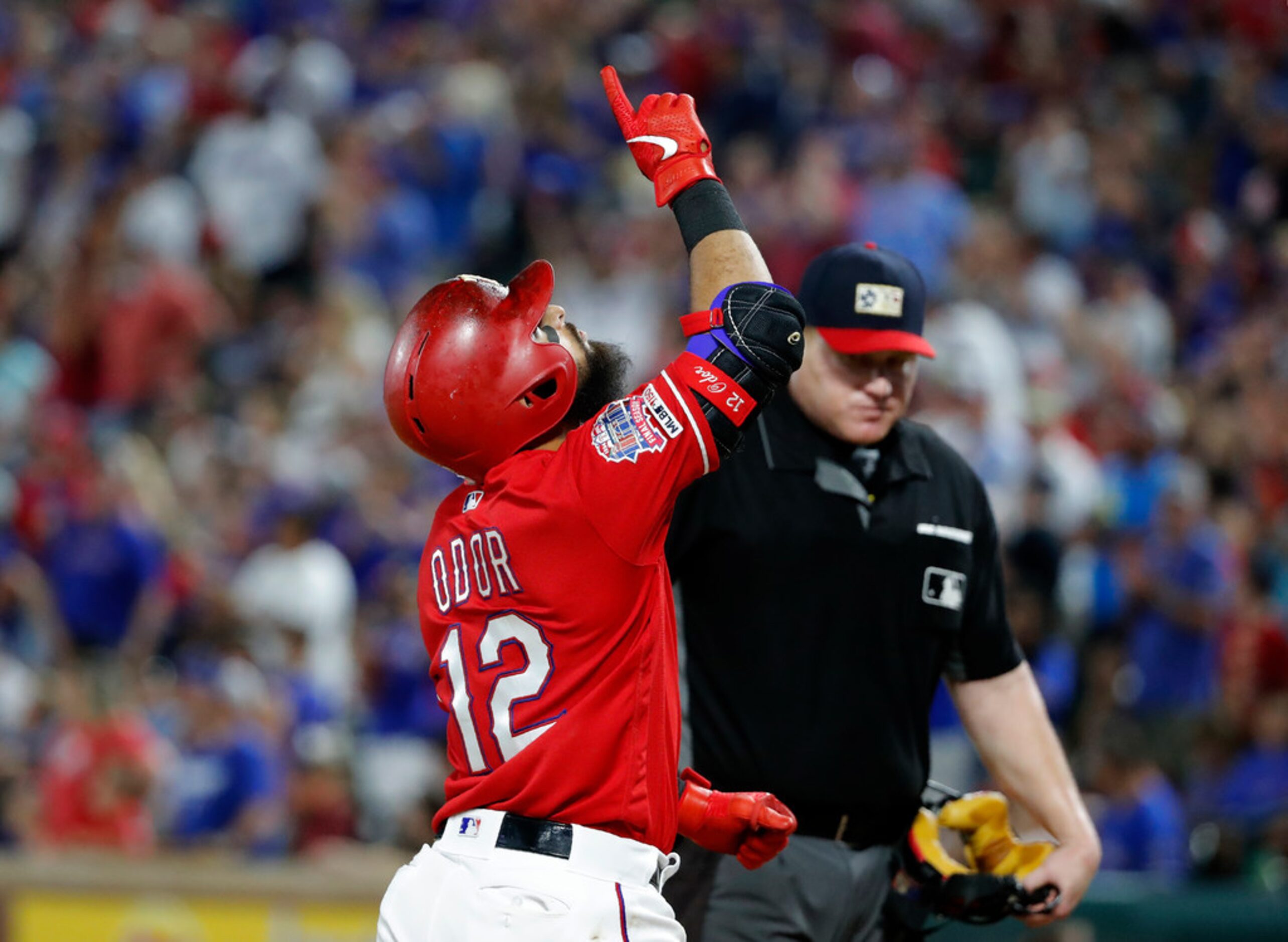 Texas Rangers' Rougned Odor (12) points skyward as he crosses the plate on his three-run...