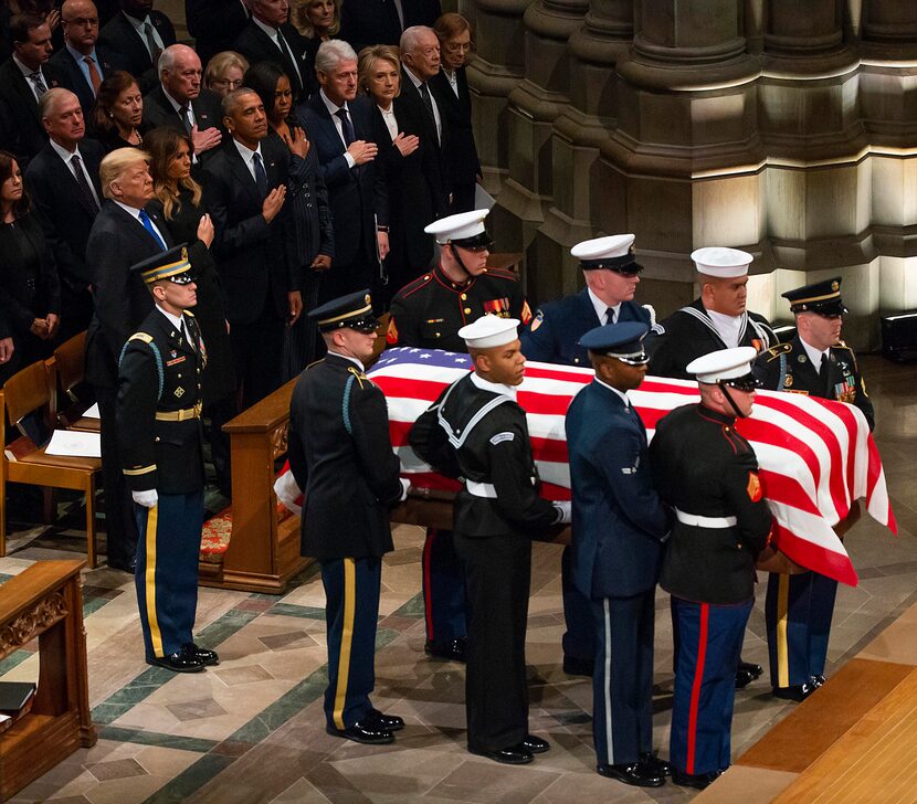 A military honor guard carries the flag-draped casket into the Washington National Cathedral...