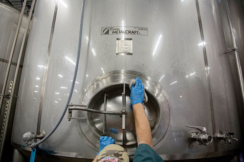 Gary James (left) cleans off tanks at Rahr & Sons Brewing Company Friday, September 30, 2016...