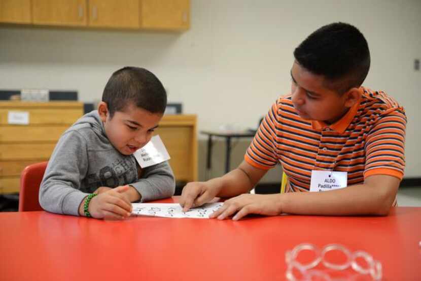 
Volunteer Aldo Padilla (right) teaches the alphabet to Daniel Melendez during the Vickery...
