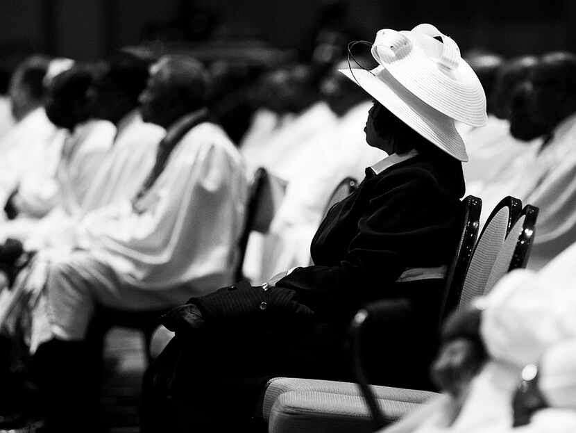  A woman wears a white hat during a communion and feet washing service at The National...