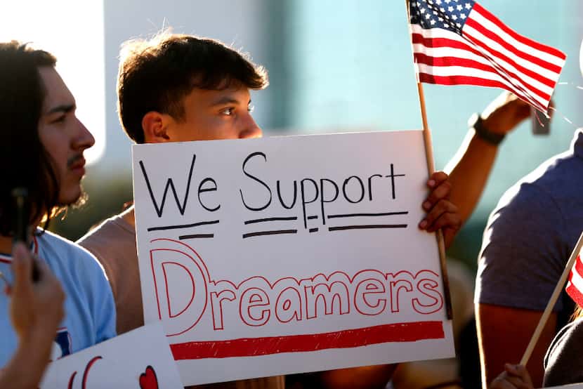 Jordin Chavez stands in the crowd with a sign during a support rally for DACA recipients at...
