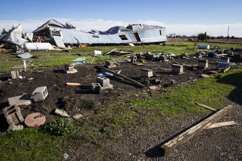 The destroyed home of Jose and Zuleyma Santillano sits separated from its foundation in the...