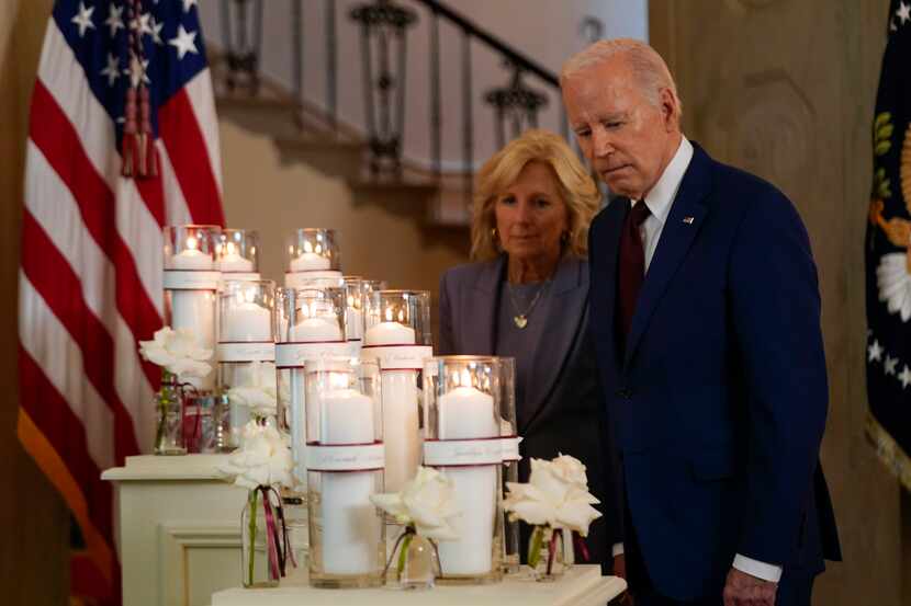 President Joe Biden and first lady Jill Biden pause May 24, 2024, at a White House memorial...
