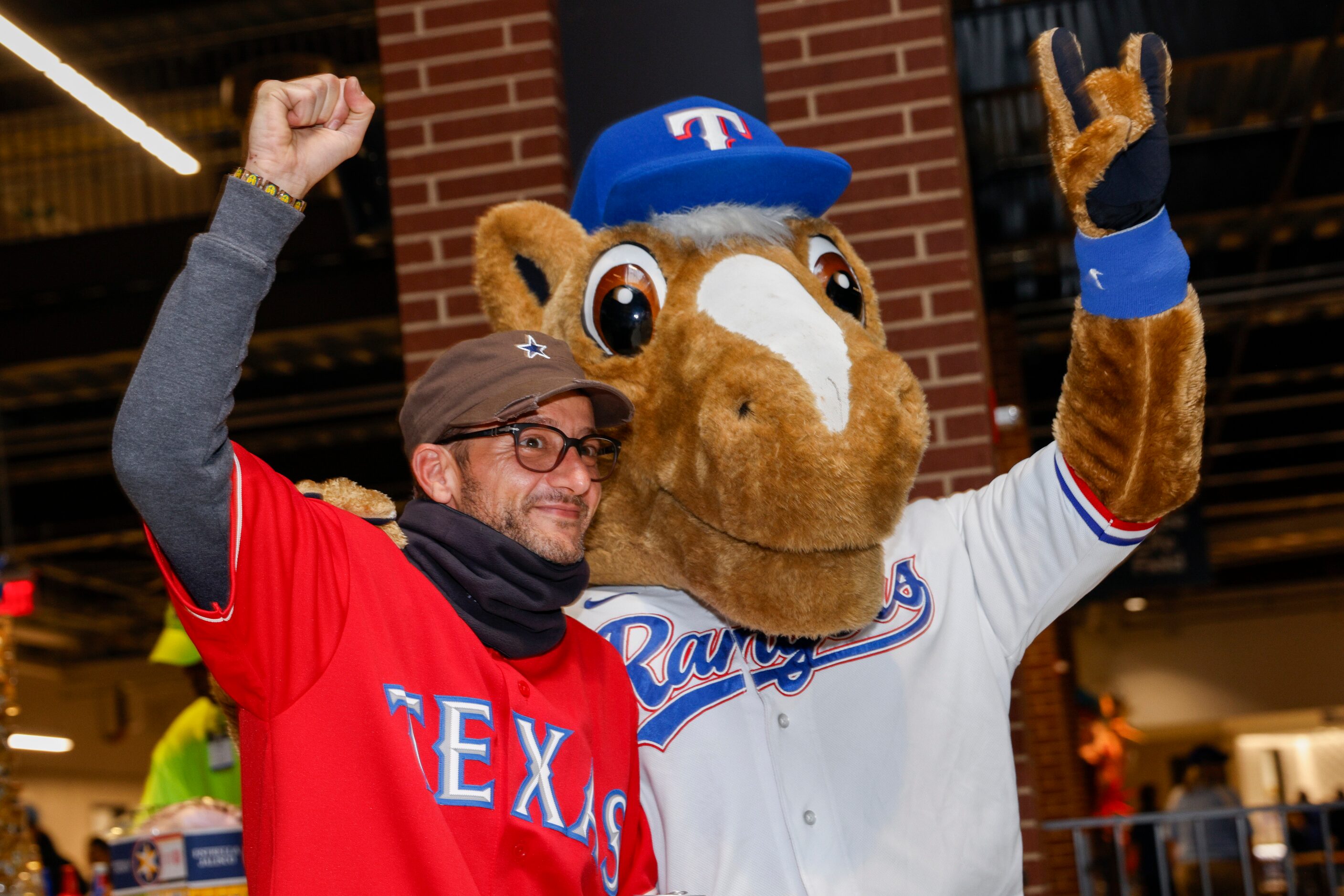 Talal Dia poses for a photo with Texas Rangers mascot Capitan before Game 3 of the World...