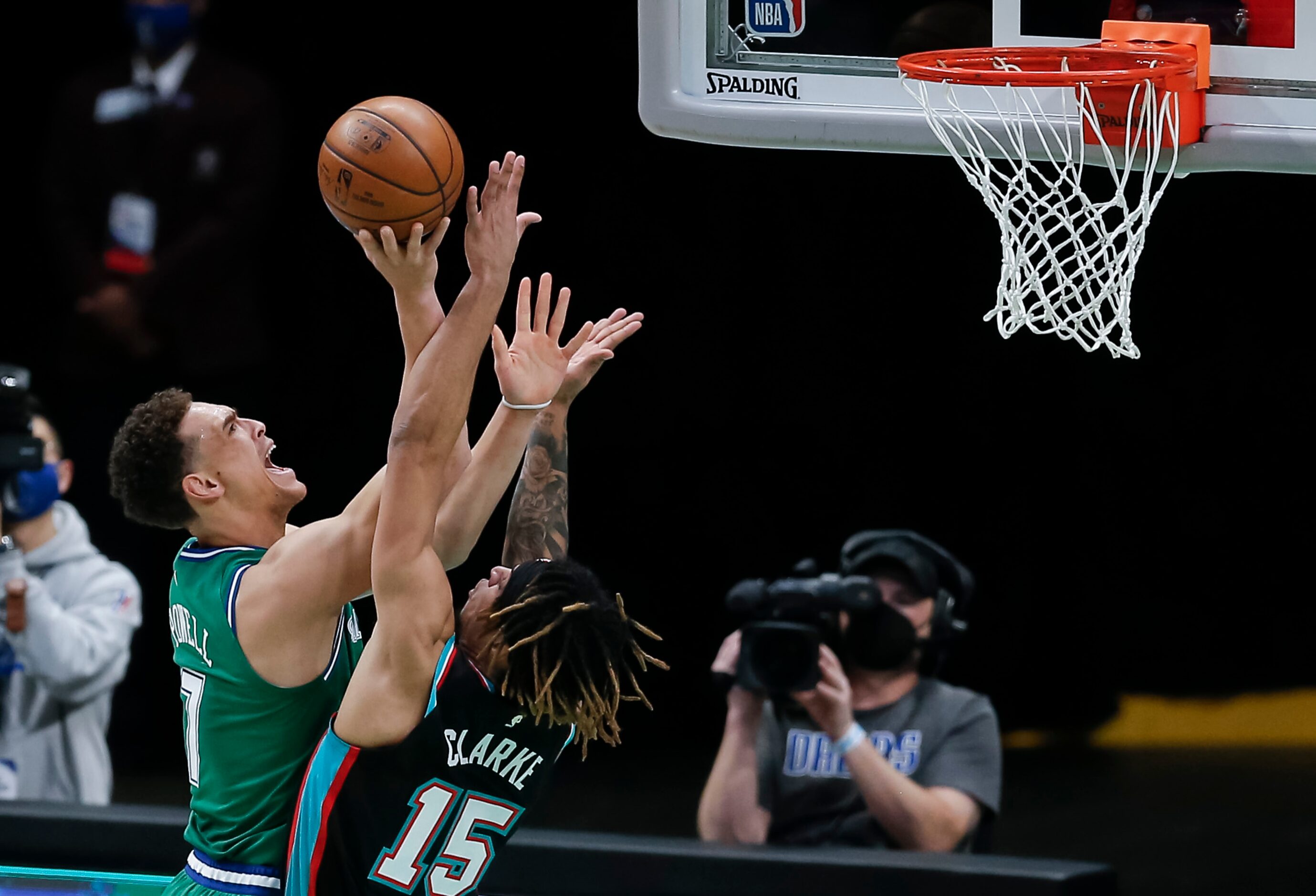 Dallas Mavericks forward Dwight Powell (7) attempts a shot as Memphis Grizzlies forward...