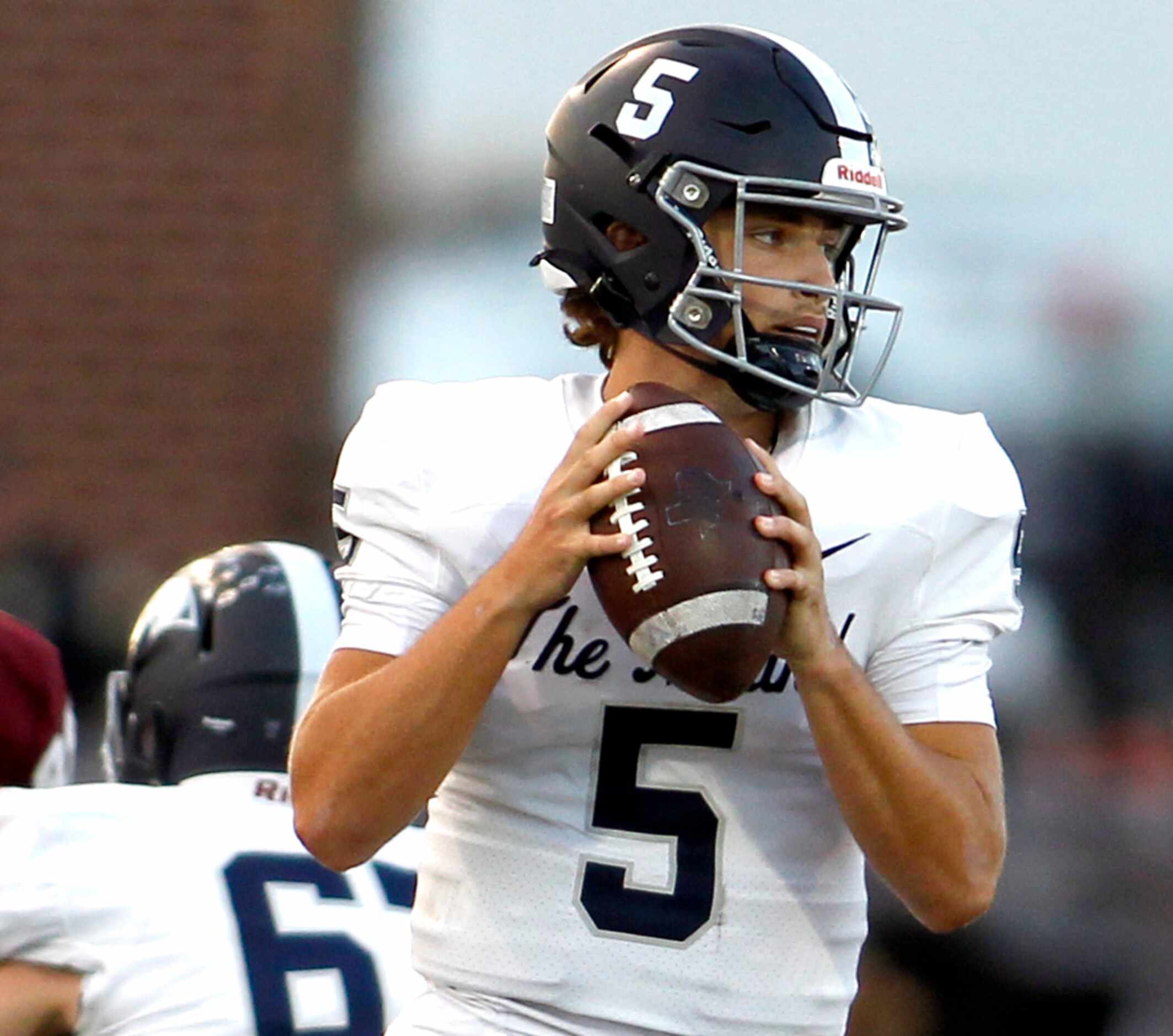 Flower Mound quarterback Jake Watson (5) looks to pass during first half action against...