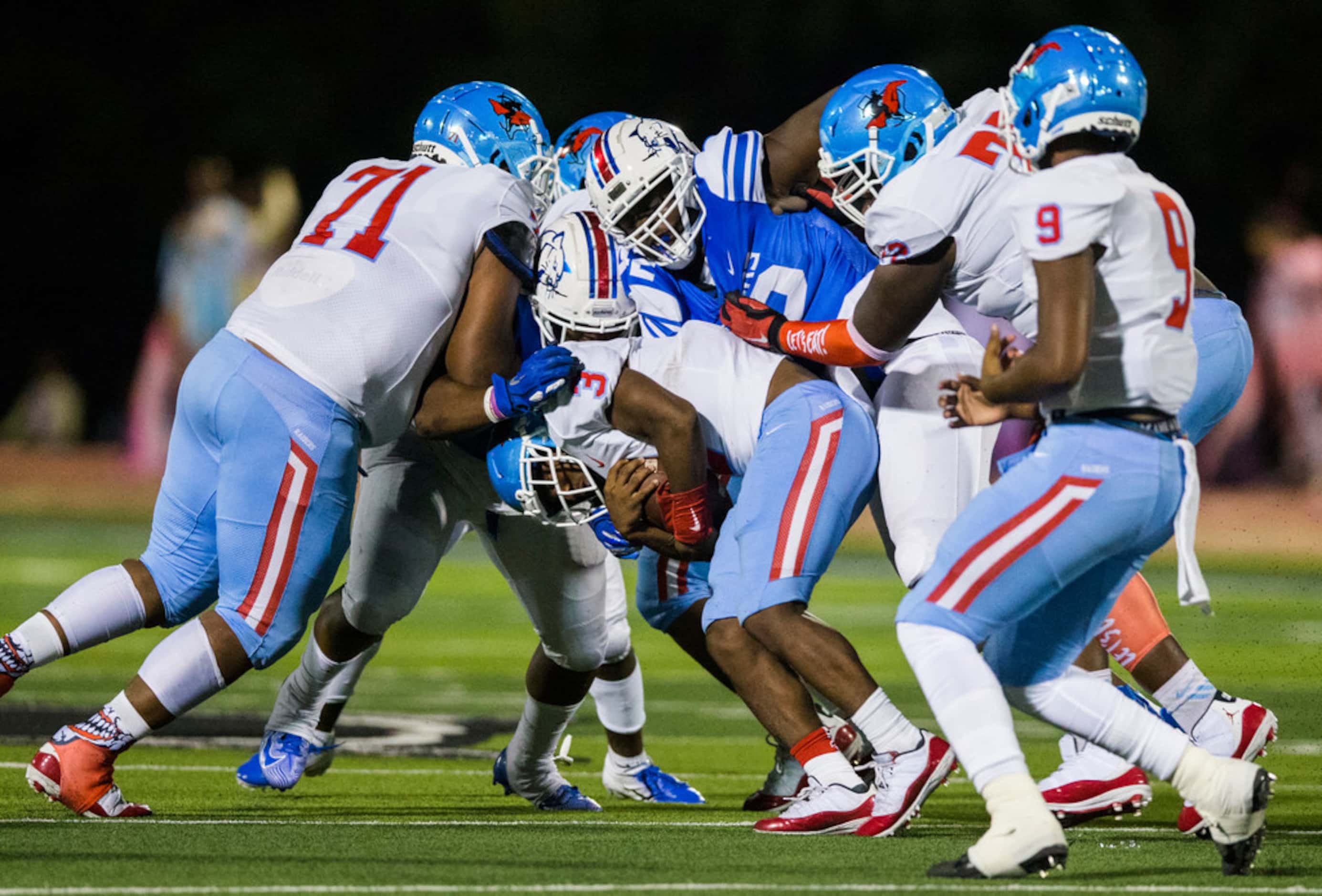 Skyline running back Jalynn Lester (3) is tackled by Duncanville defenders during the first...