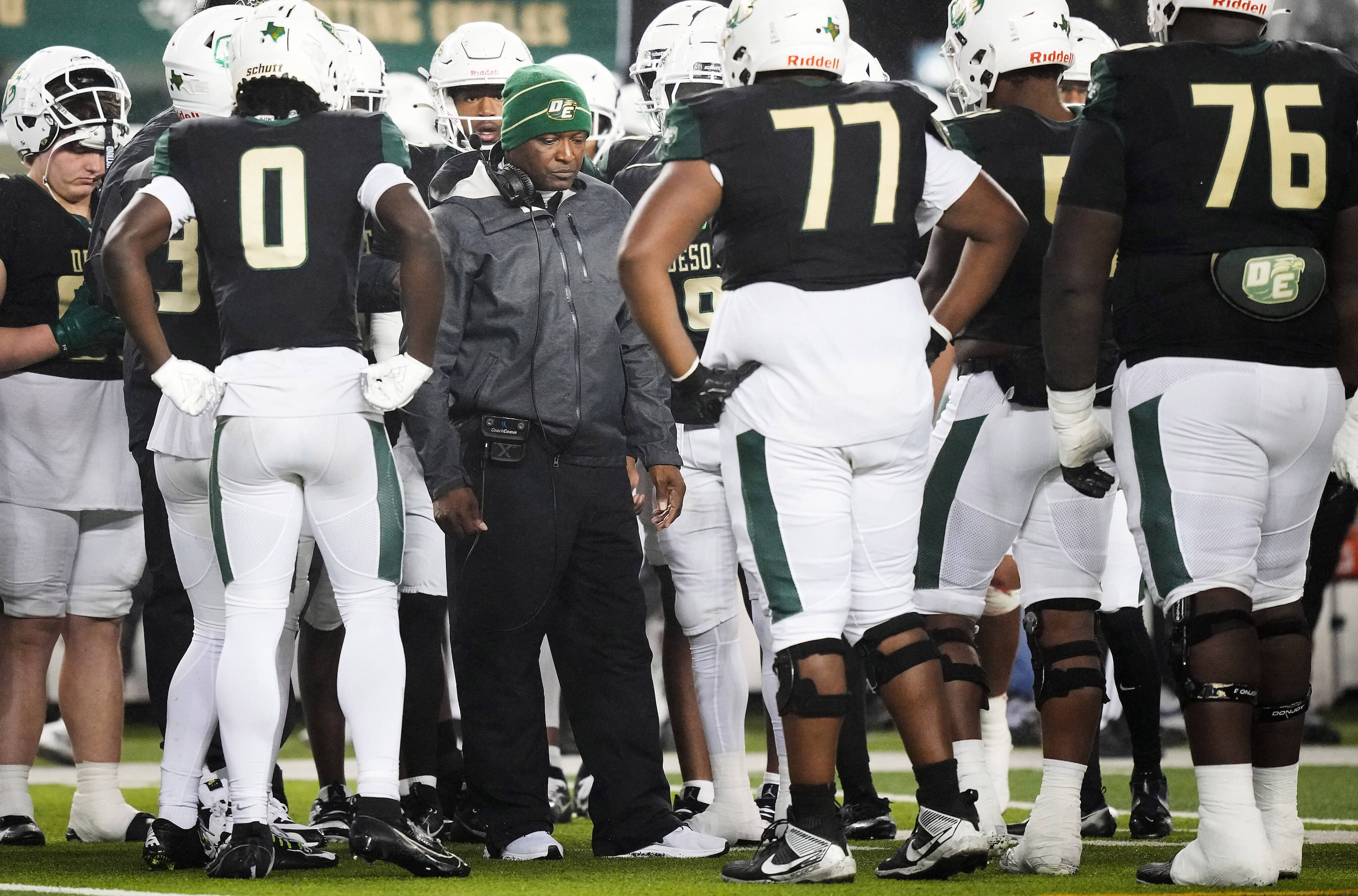 DeSoto players huddle around head coach Claude Mathis during the second half of the Class 6A...