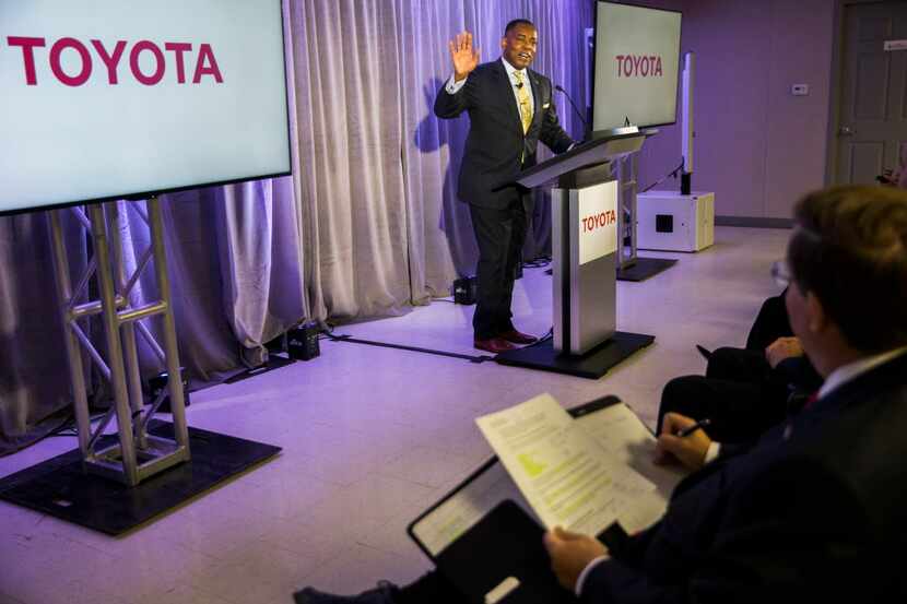 Harry LaRosiliere, mayor of Plano, makes a comment to Jim Lentz, right, CEO of Toyota Motor...