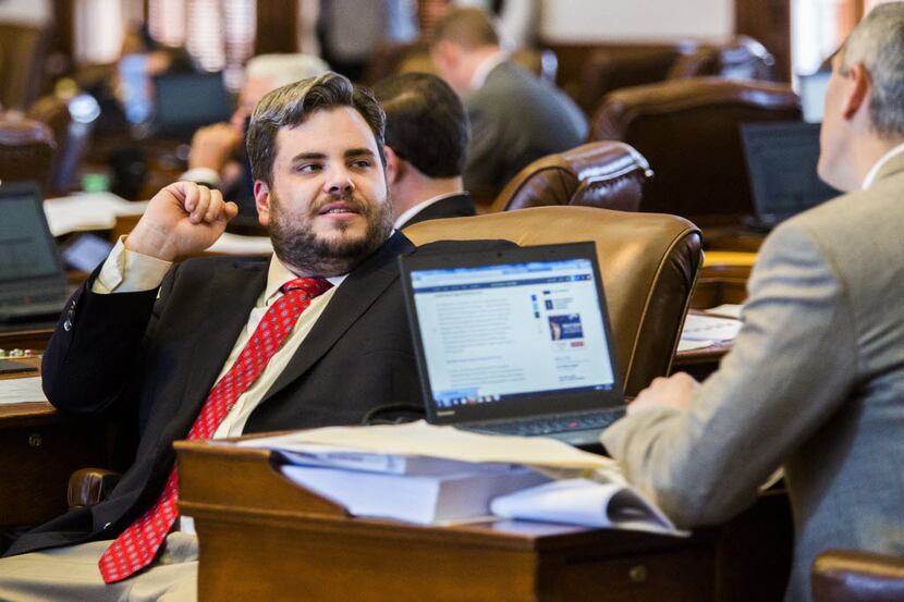 Rep. Jonathan Stickland, R-Bedford, left, talks to a colleague during the final days of the...