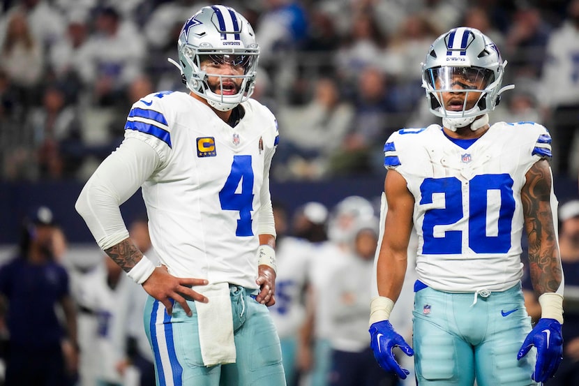 Dallas Cowboys quarterback Dak Prescott (4) and running back Tony Pollard (20) react after a...