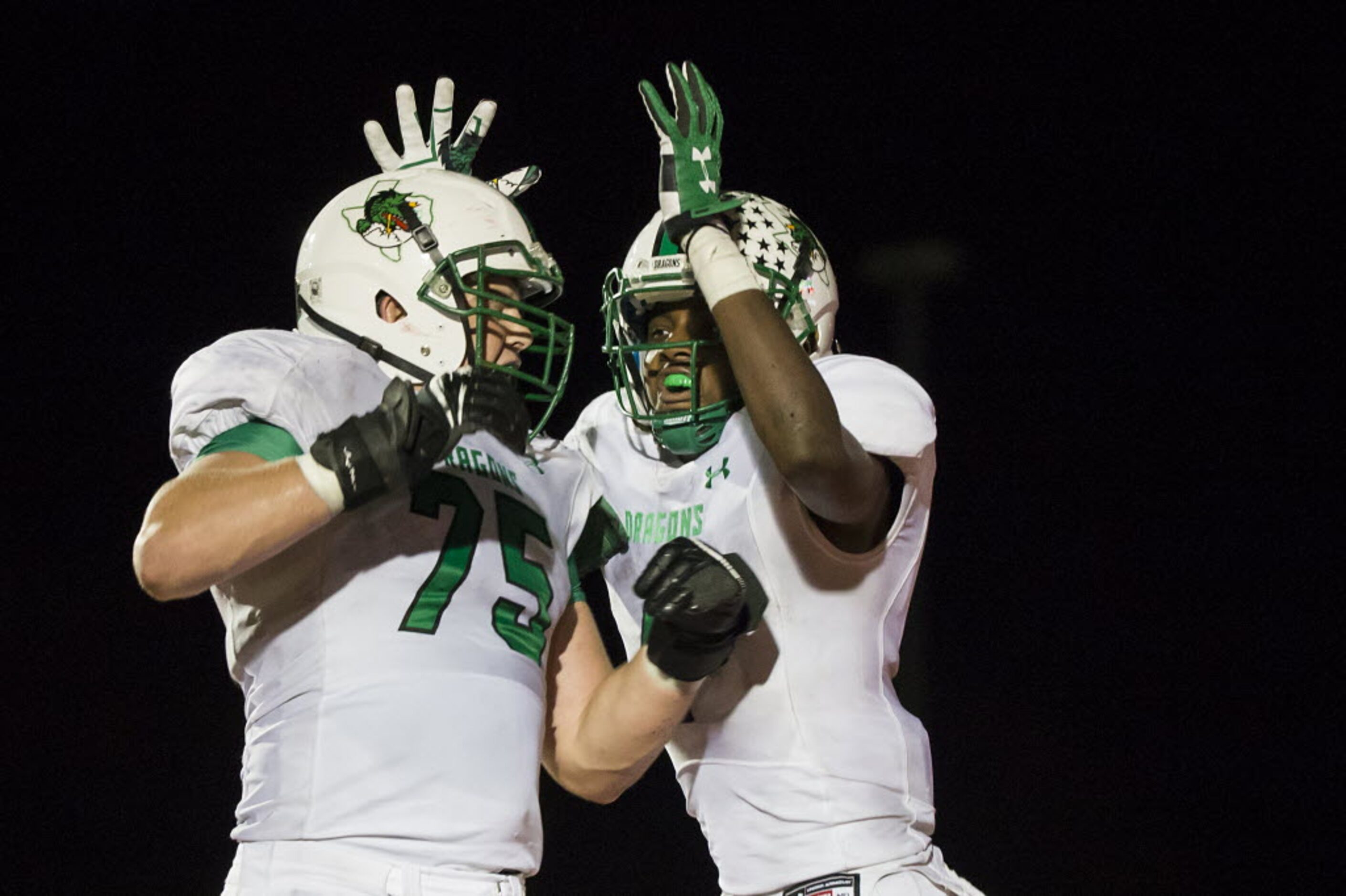 Southlake Carroll's Lil' Jordan Humphrey (4) celebrates with Chase Linton (75) after...