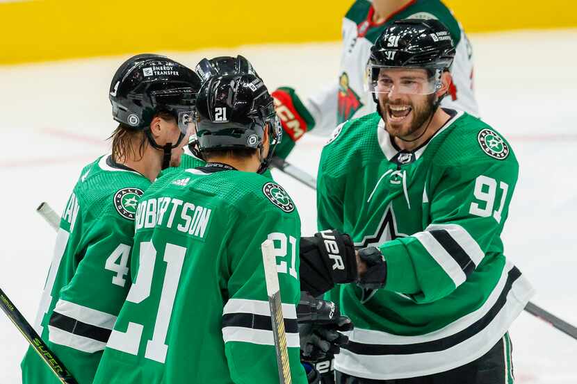 Dallas Stars center Tyler Seguin (91) celebrates a goal by center Joe Pavelski (16) with...