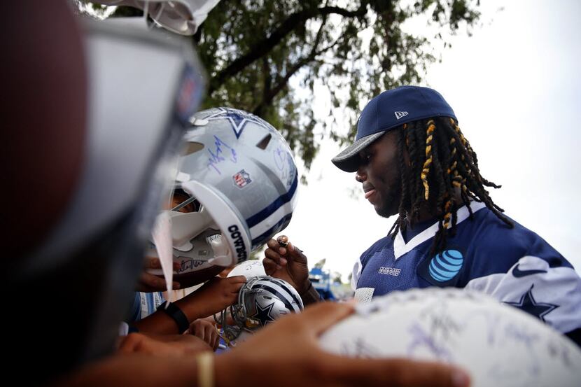 FILE - Dallas Cowboys outside linebacker Jaylon Smith (54) signs autographs for fans during...