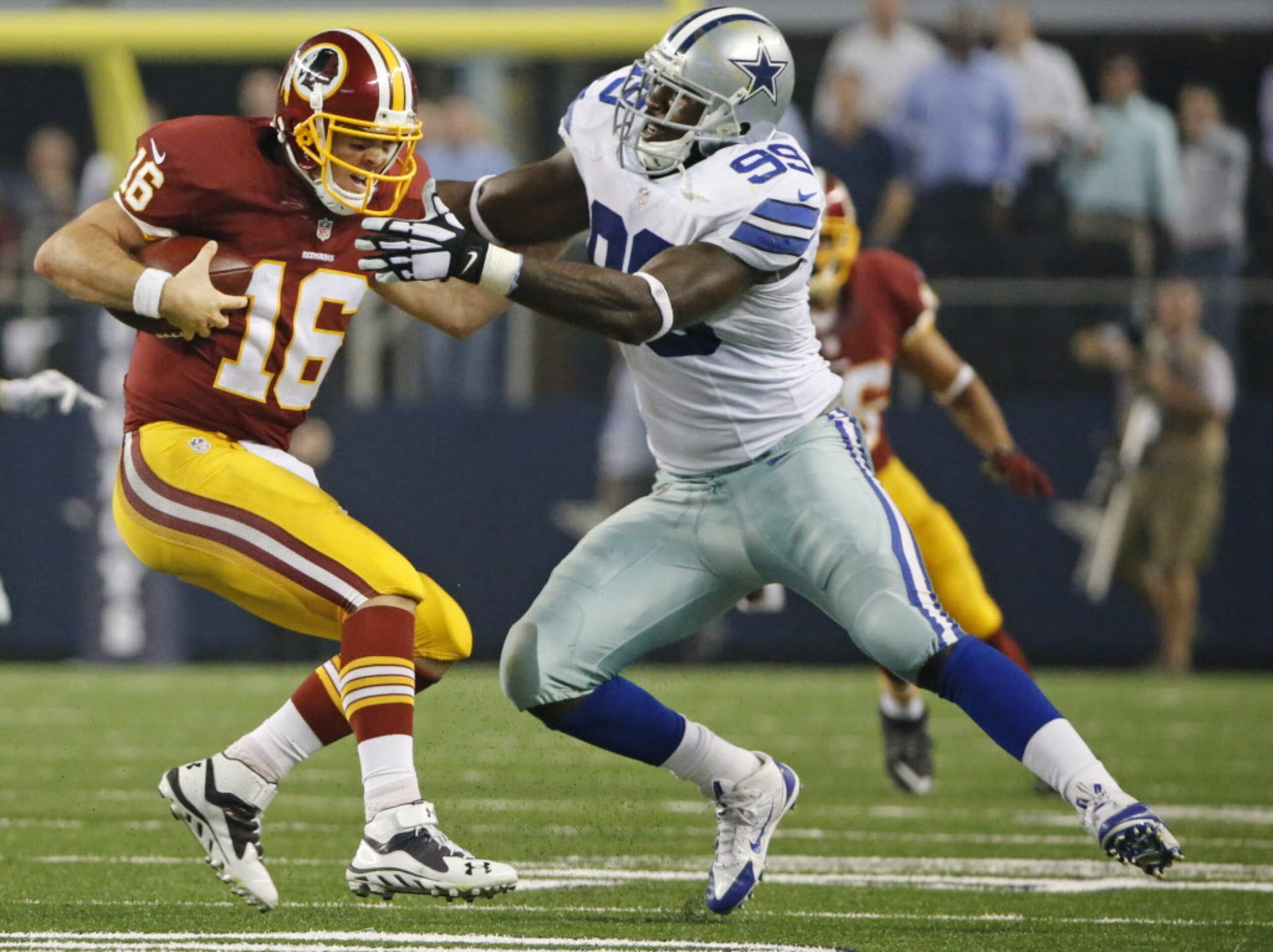 Dallas Cowboys defensive end George Selvie (99) tries to make the tackle on Washington...