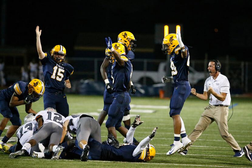 Arlington Lamar celebrates recovering a turnover against Alrington Martin in the first half...