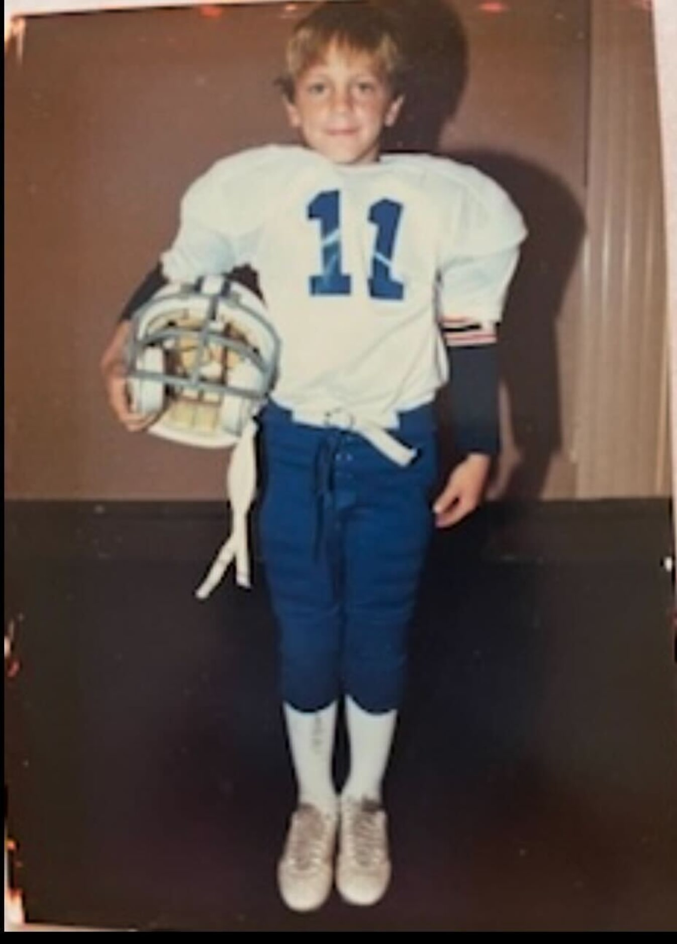 A young Mike Elko in his football uniform.