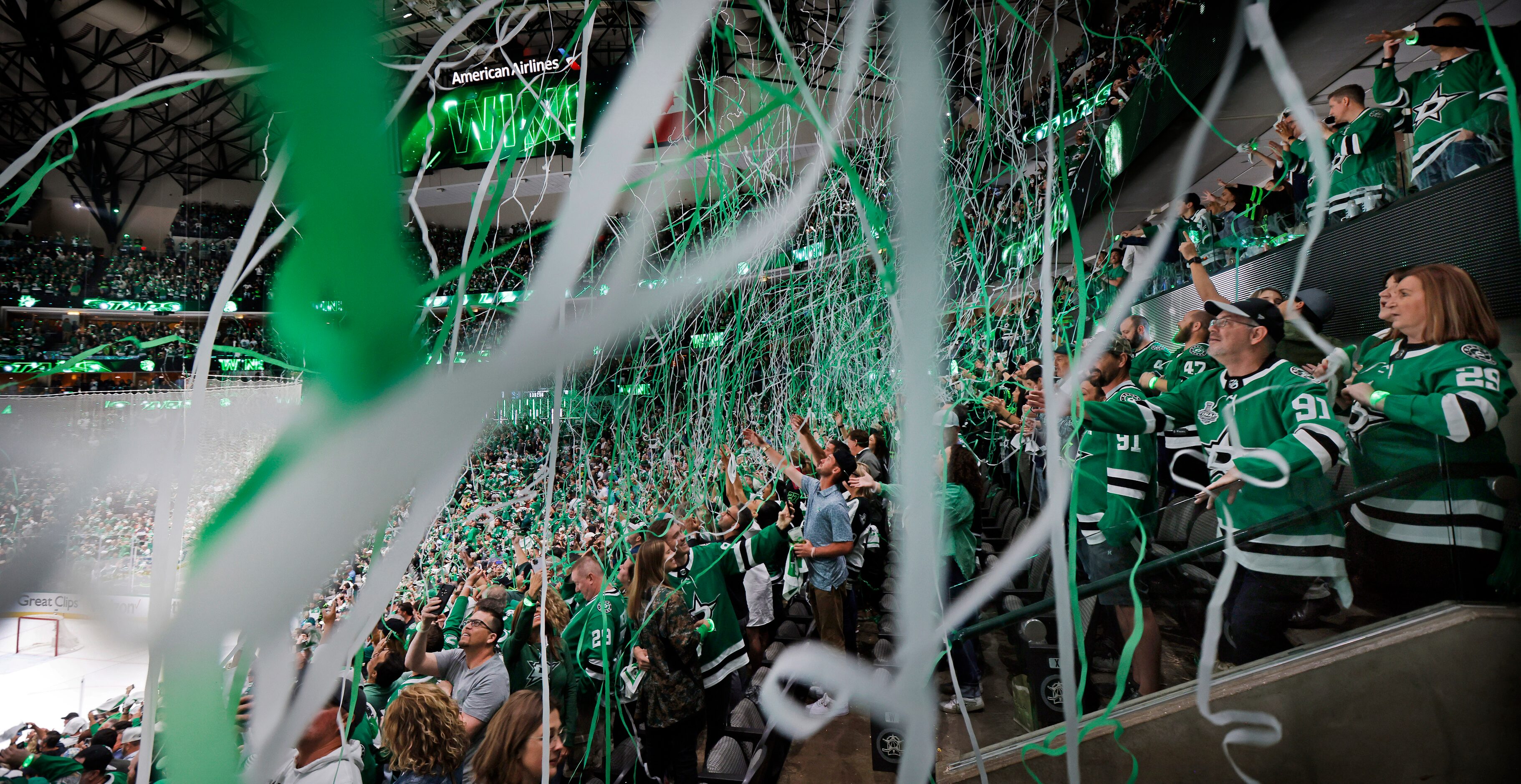 With paper streamers falling from the ceiling, Dallas Stars fans celebrate their series win...