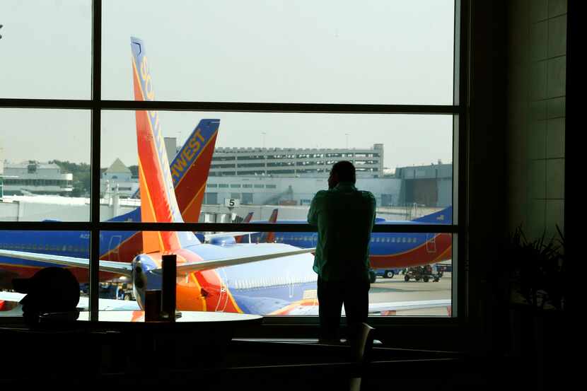 A passenger watches from the Southwest Airlines terminal at Dallas Love Field in 2015. 