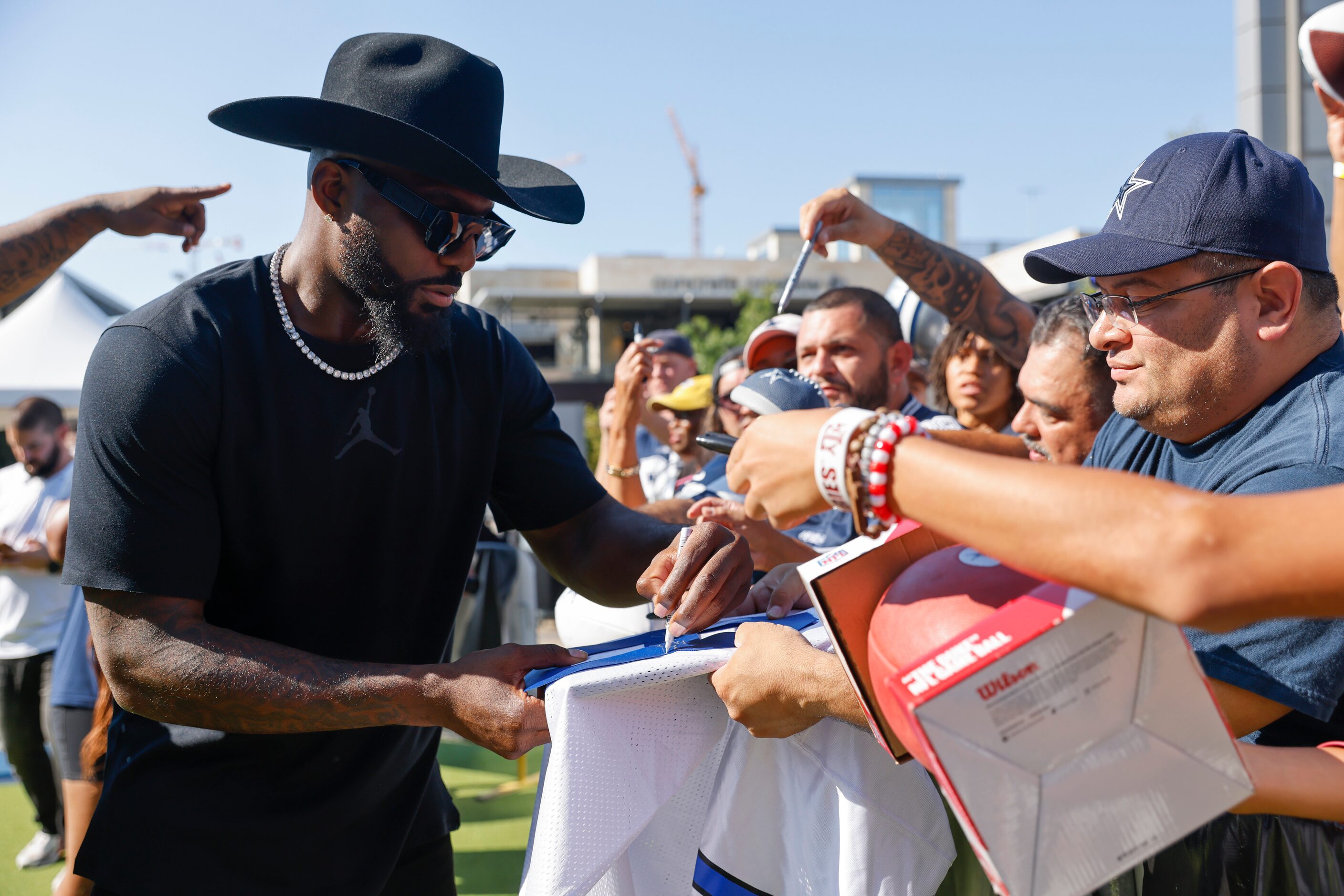 Former Dallas Cowboys player Dez Bryant gives autographs to the crowd during the recording...