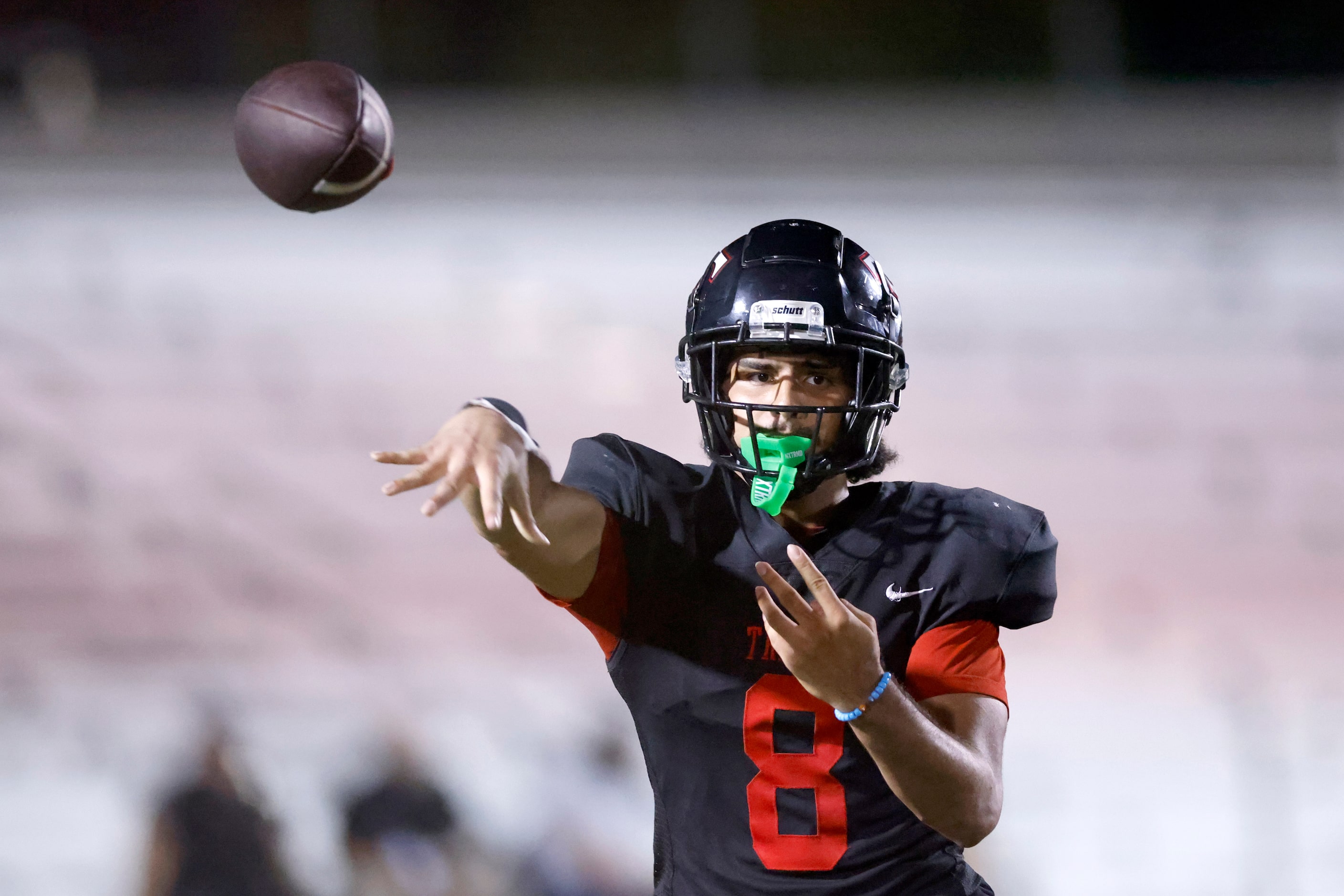 Euless Trinity quarterback TJ Tupou (8) throws a pass during the second half of a District...