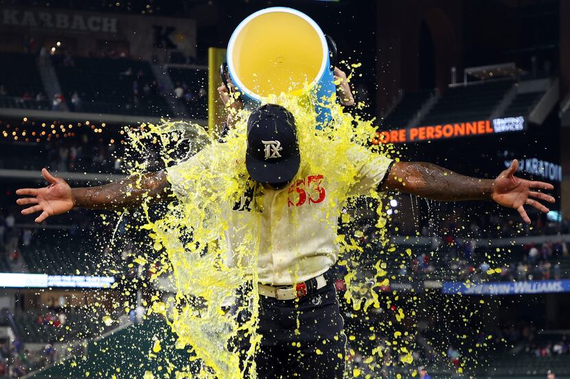 Texas Rangers' Adolis Garcia (53) gets doused with a sports drink after a game against the...