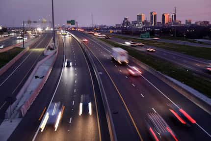 Evening commuters use the TEXpress Lanes on I-35W (southbound, center right) where a 130-car...