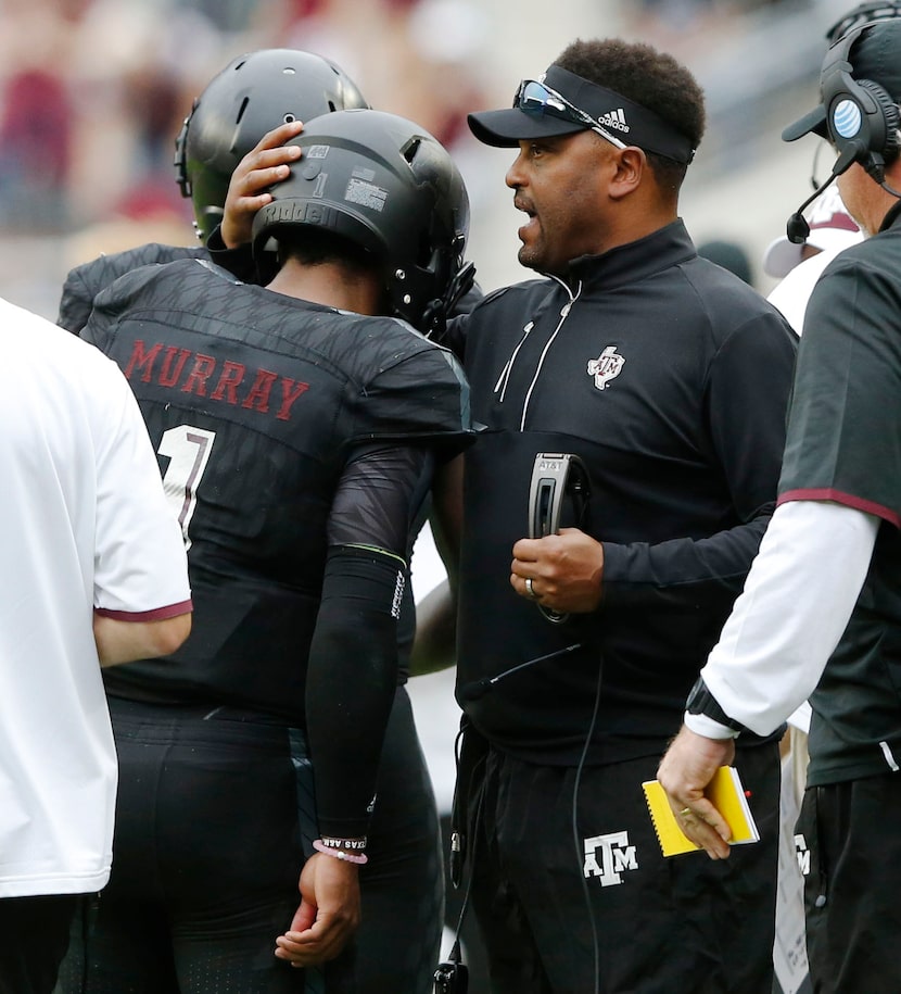 Texas A&M Aggies head coach Kevin Sumlin congratulates Texas A&M Aggies quarterback Kyler...