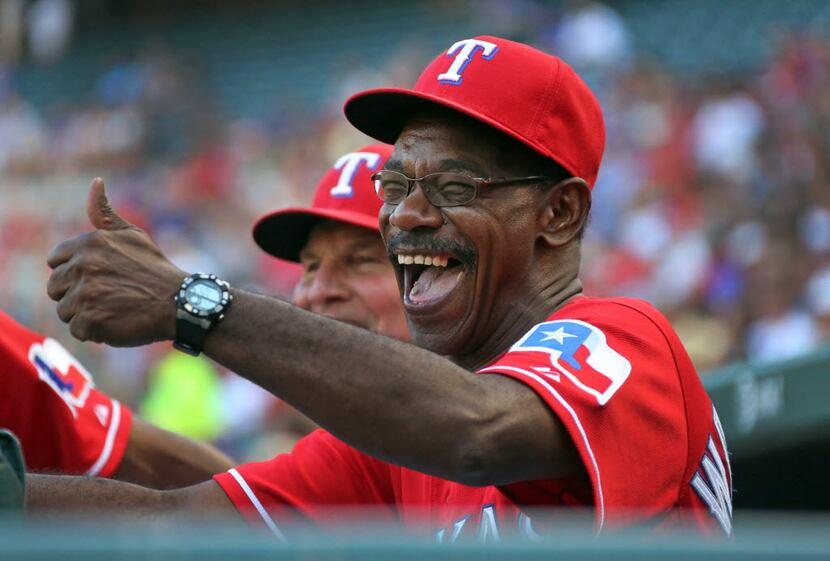 Texas manager Ron Washington shares a laugh with bench coach Jackie Moore before the Houston...