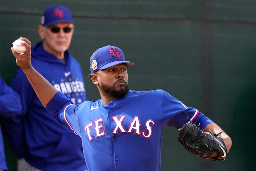 Texas Rangers manager Bruce Bochy watches while pitcher Kumar Rocker throws during spring...