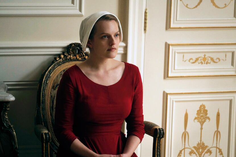 This image released by Hulu shows Elisabeth Moss as Offred in a scene from, "The Handmaid's...