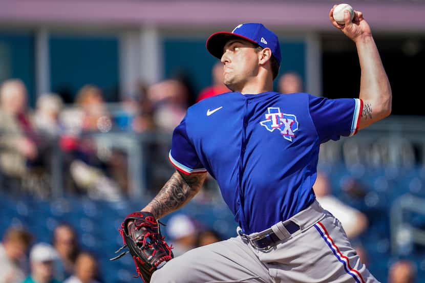 Texas Rangers pitcher Joe Palumbo pitches during the first inning of a spring training game...