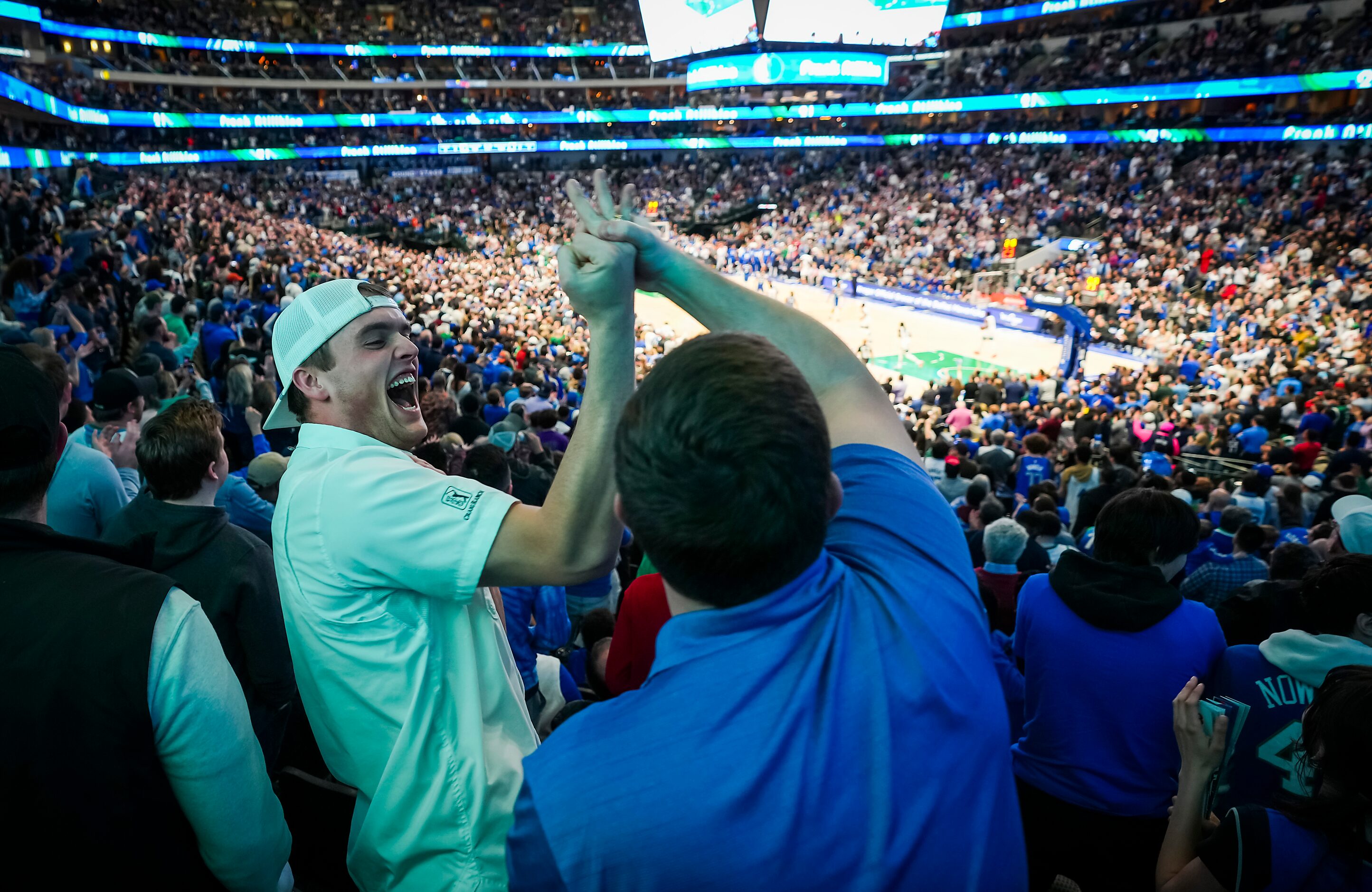 Dallas Mavericks fan  Peyton Steele celebrates with other fans after a 3-pointer by guard...