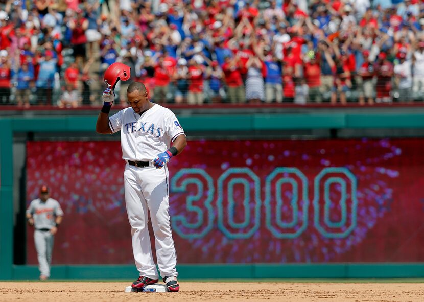 FILE - Texas Rangers' Adrián Beltré tips his helmet as he acknowledges cheers after hitting...