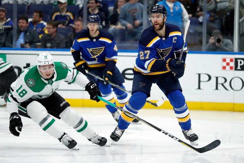 St. Louis Blues' Alex Pietrangelo (27) passes the puck past Dallas Stars' Tyler Pitlick (18)...