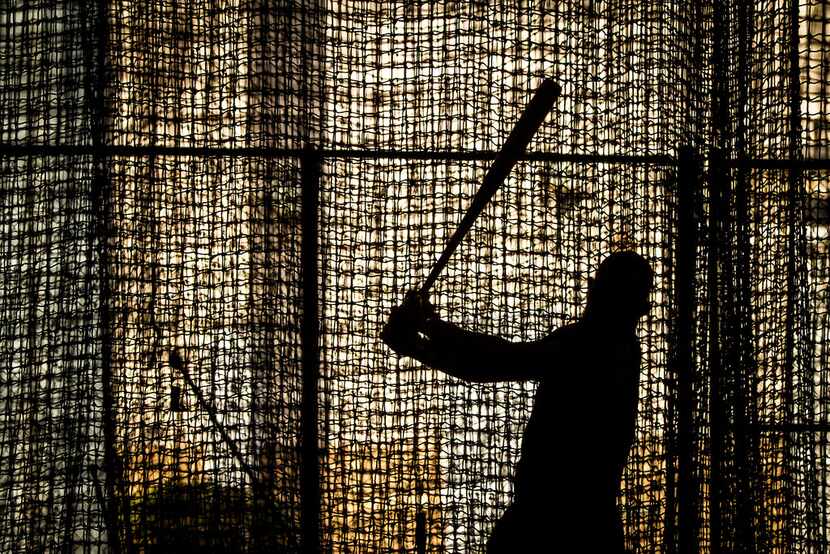 Texas Rangers second baseman Rougned Odor takes batting practice in one of the indoor cages...