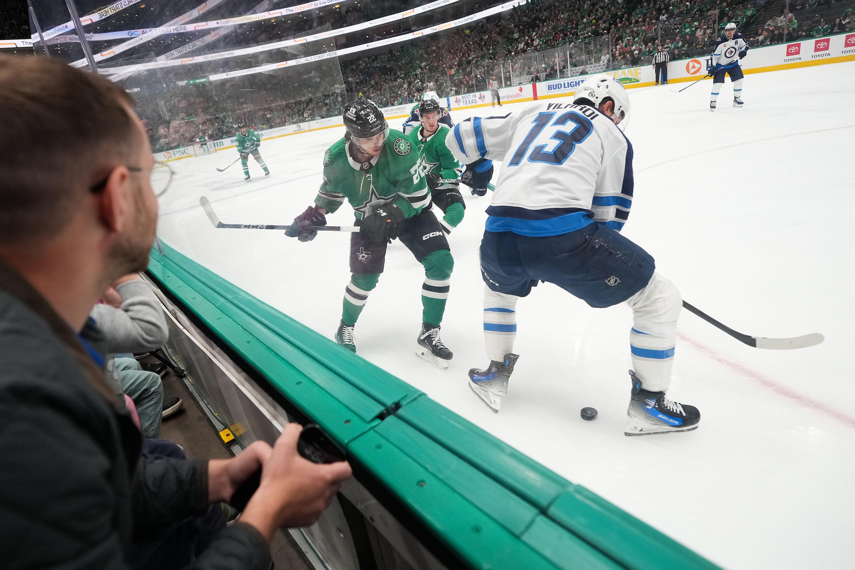 Dallas Stars center Mavrik Bourque (22) fights for the puck against Winnipeg Jets center...