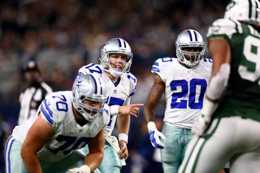 ARLINGTON, TX - DECEMBER 19: Kellen Moore #17 of the Dallas Cowboys calls a play against the...