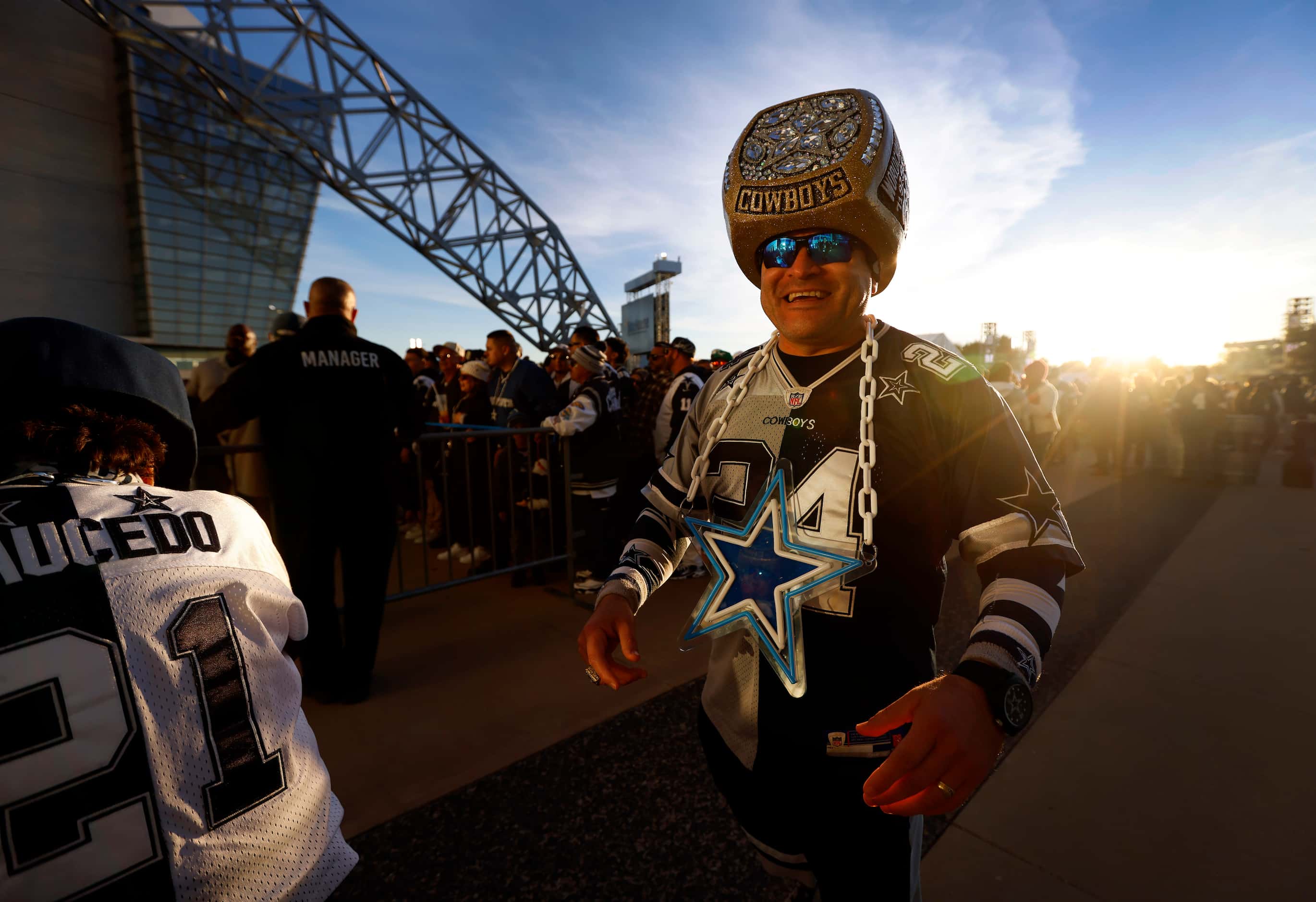 Donning a Super Bowl ring helmet, Steven Saucedo of San Antonio waits on the West Plaza to...