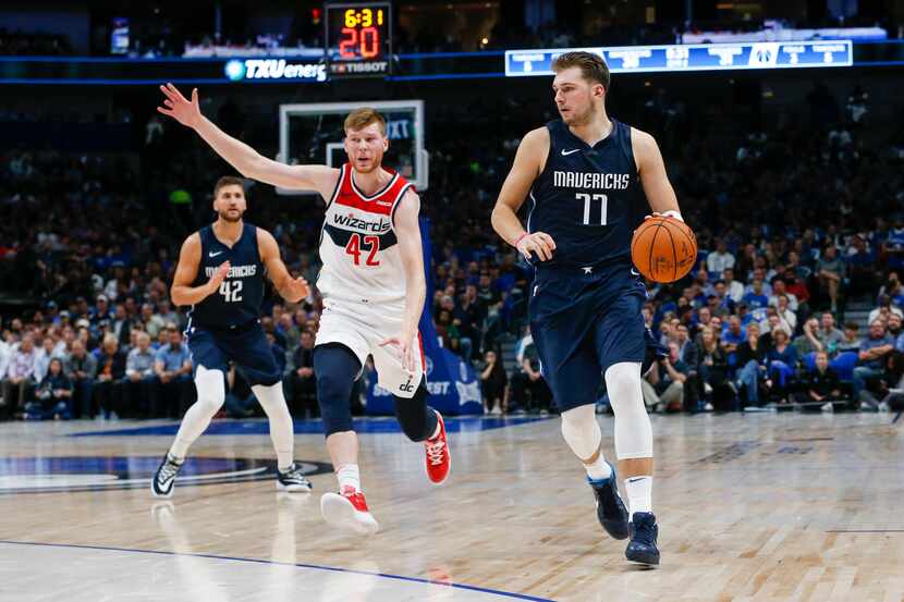 Dallas Mavericks forward Luka Doncic (77) drives downcourt past Washington Wizards forward...