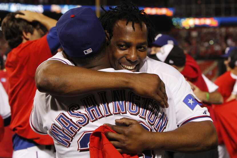 Texas Rangers manager Ron Washington hugs Vladimir Guerrero after they beat the New York...