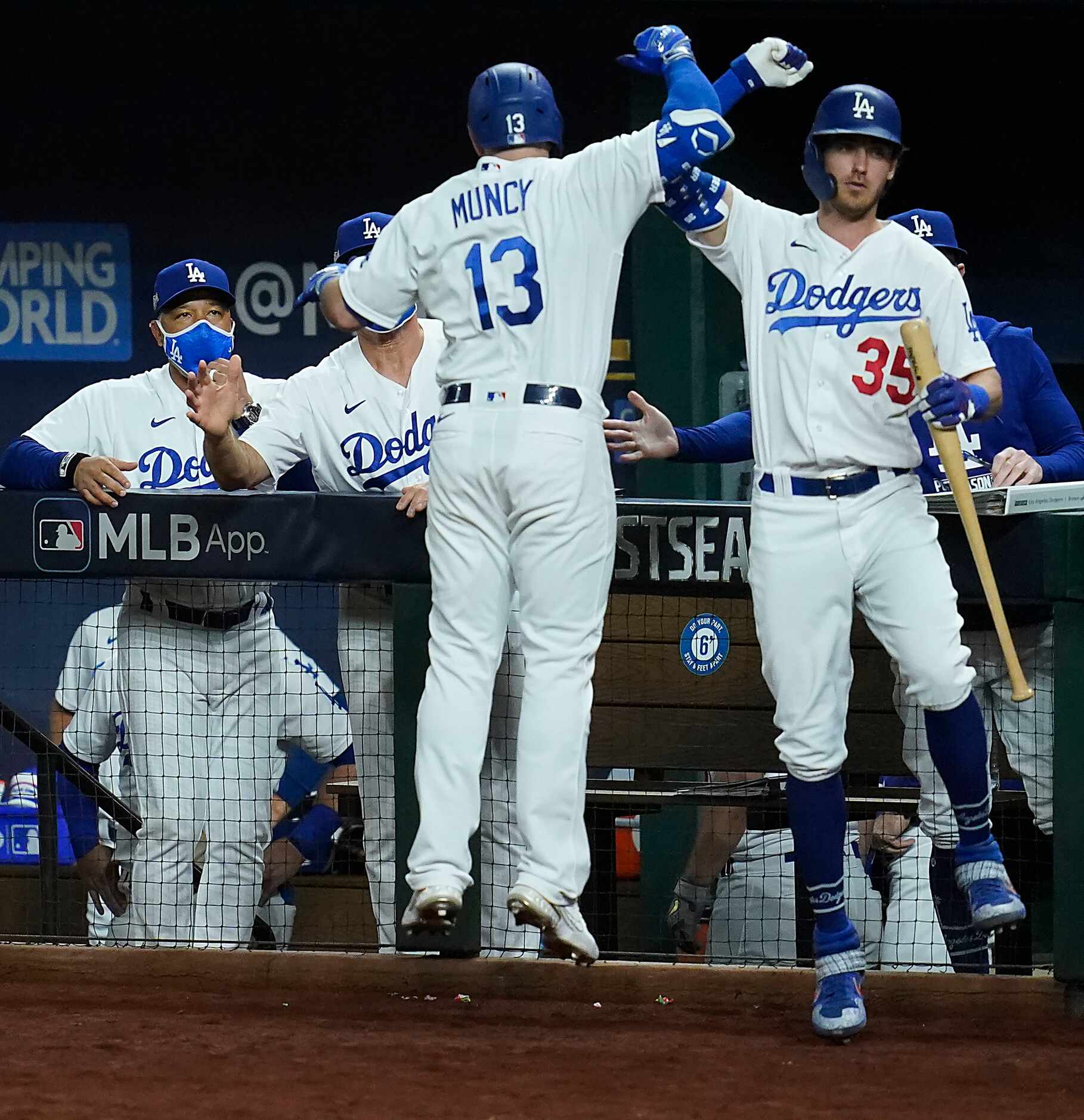Los Angeles Dodgers first baseman Max Muncy celebrates with center fielder Cody Bellinger...