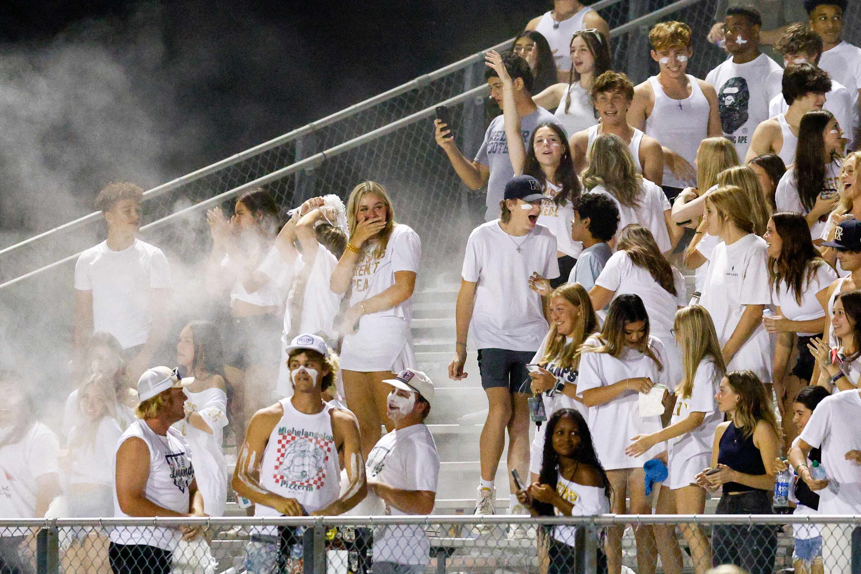 Keller students throw baby powder as they celebrate a touchdown during the second half of a...