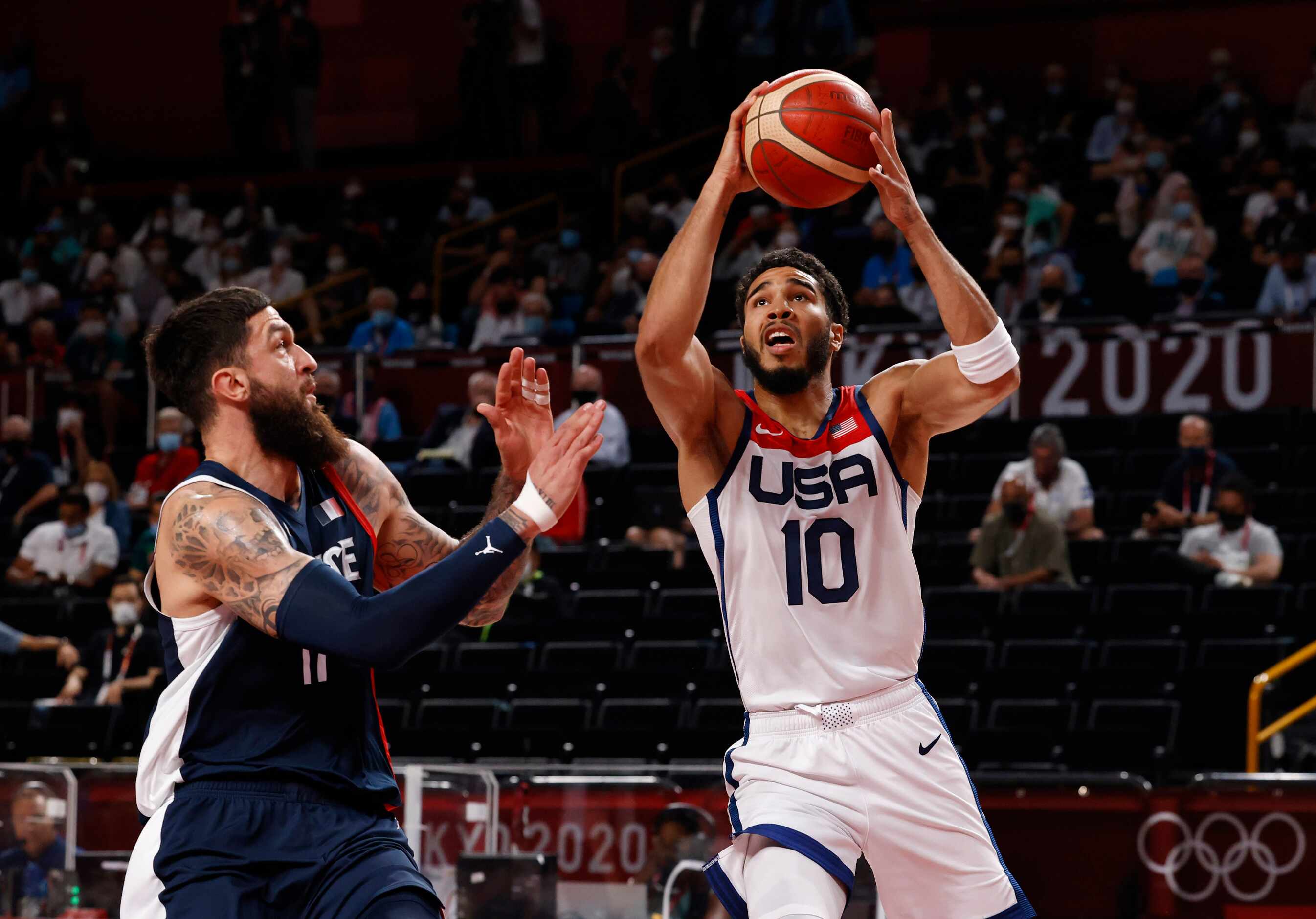 USA’s Jayson Tatum (10) drives on France’s Vincent Poirier (17) during the first half of...