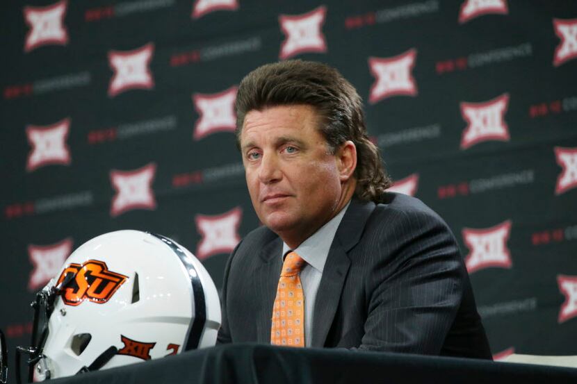 Oklahoma State head coach Mike Gundy listens to a reporters question during the Big 12 NCAA...