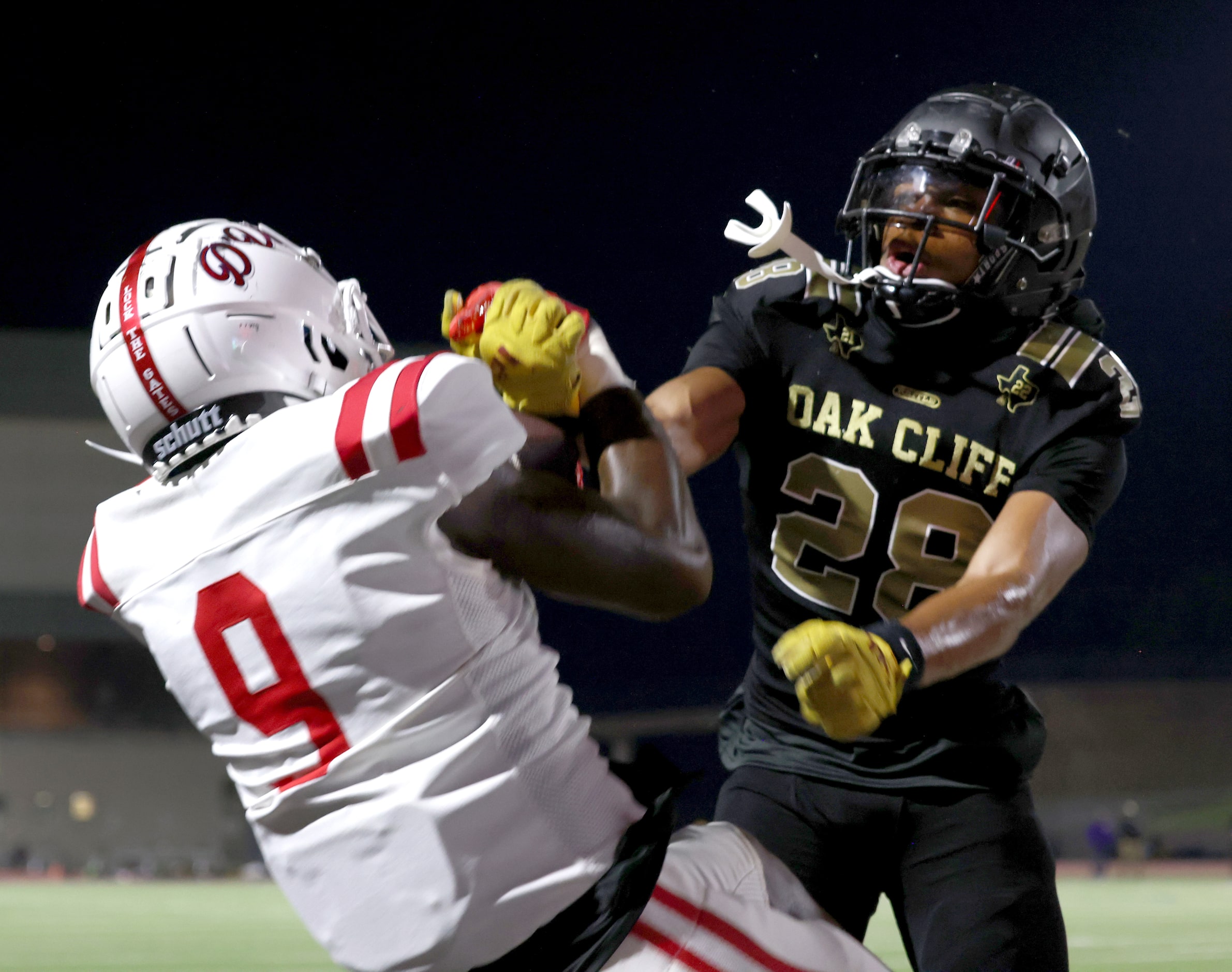 South Oak Cliff defensive back Xavier Mayfield (28) right, is unable to wrestle the ball...