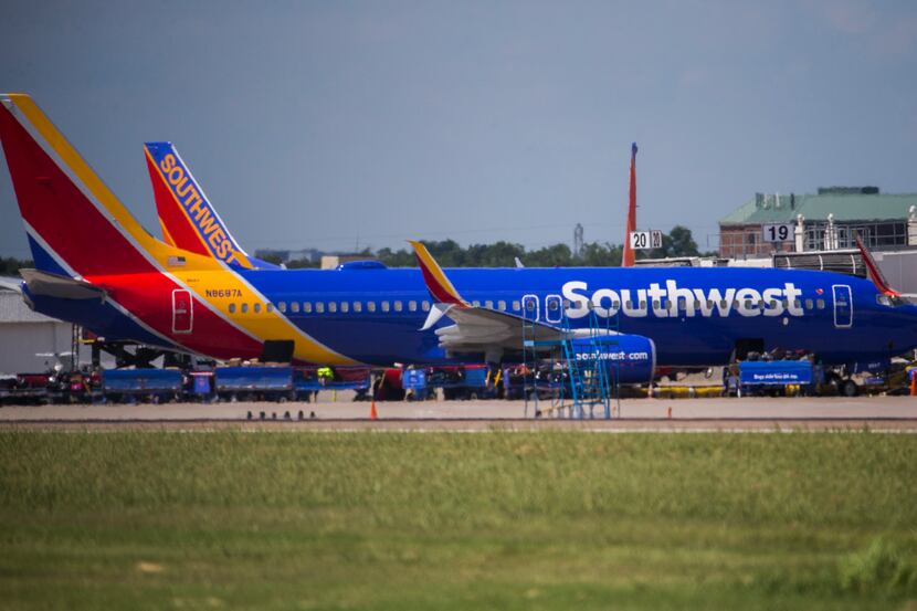 Southwest Airlines airplanes are parked at terminals while computer systems recover on...