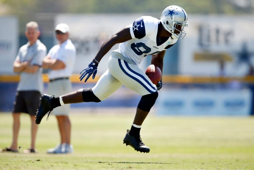 Dallas Cowboys wide receiver Dez Bryant (88) stumbles as he cuts across the field after a...