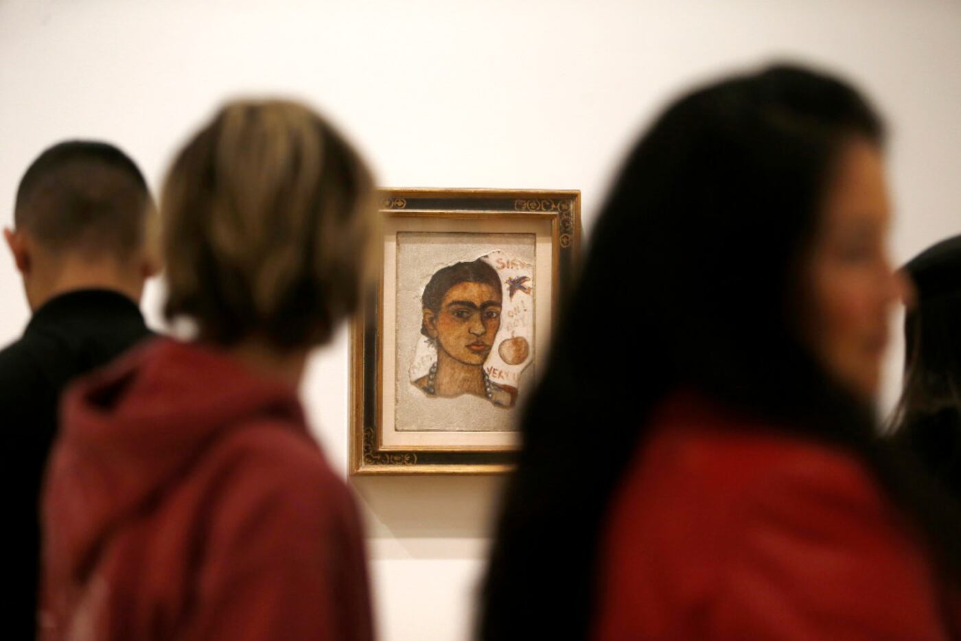 Crowds move past "Very Ugly," a fresco self portrait by Frida Kahlo at the Dallas Museum of...